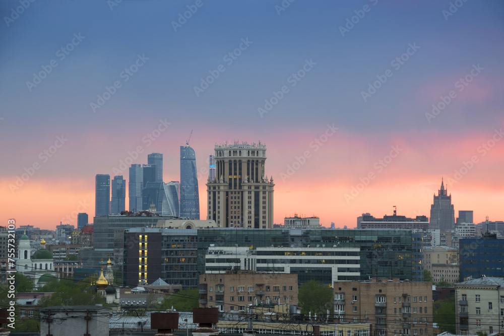 Many roofs, domes of churches and skyscrapers during sunset in Moscow, Russia