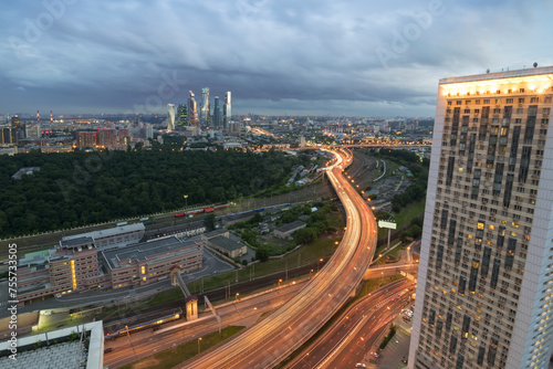 Tall residential building and modern highway at summer cloudy evening in Moscow, Russia photo