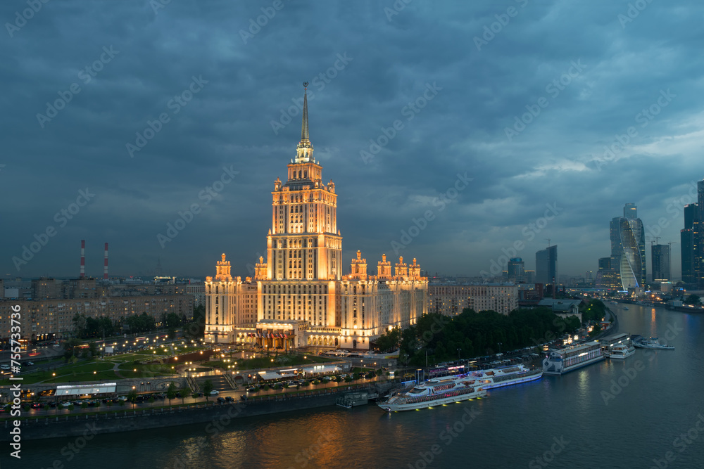 Illuminated Royal Hotel Radisson (Hotel Ukraina) near river at evening in Moscow