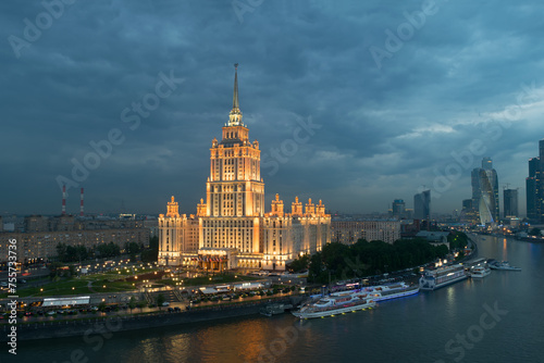 Illuminated Royal Hotel Radisson (Hotel Ukraina) near river at evening in Moscow