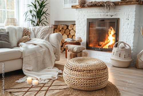 Scandinavian Living Room Rattan Lounge Chair, Wicker Pouf, and White Sofa by Fireplace