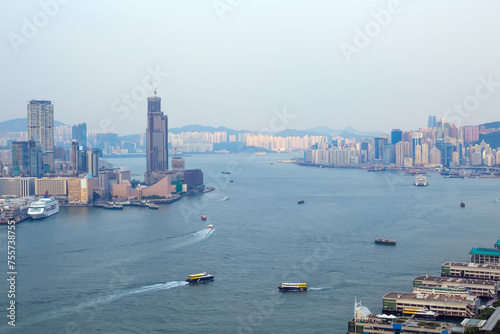 Skyscrapers on sea shore in business area, many ships at morning in Hong Kong, China, view from China Merchants Tower