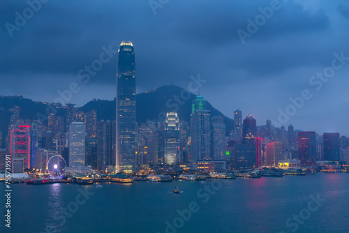 Evening International Commerce Centre with illumination, sea shore, mountains and ships in Hong Kong, China, view from Starhouse