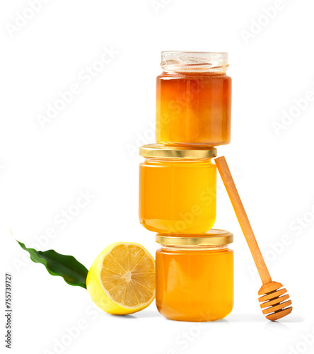 jars with honey one on top of the other and a stick for honey on a white background