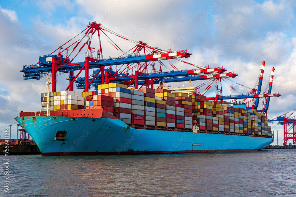 Fototapeta premium Container ship loading and unloading in port. Logistic import and export freight transportation by container ship.
