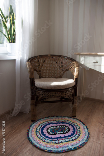 Handmade rug near a wicker chair