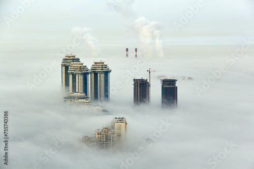 Residential complex Sparrow Hills (Vorobyovy Gory) and construction site of residential complex Dolina Setun in morning fog. photo