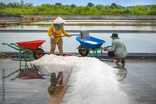 Farmers are harvesting salt in Ly Nhon, Can Gio district, Ho Chi Minh City, Vietnam. The salt making profession has a long history in this locality and salt is supplied mainly to people in Ho Chi Minh