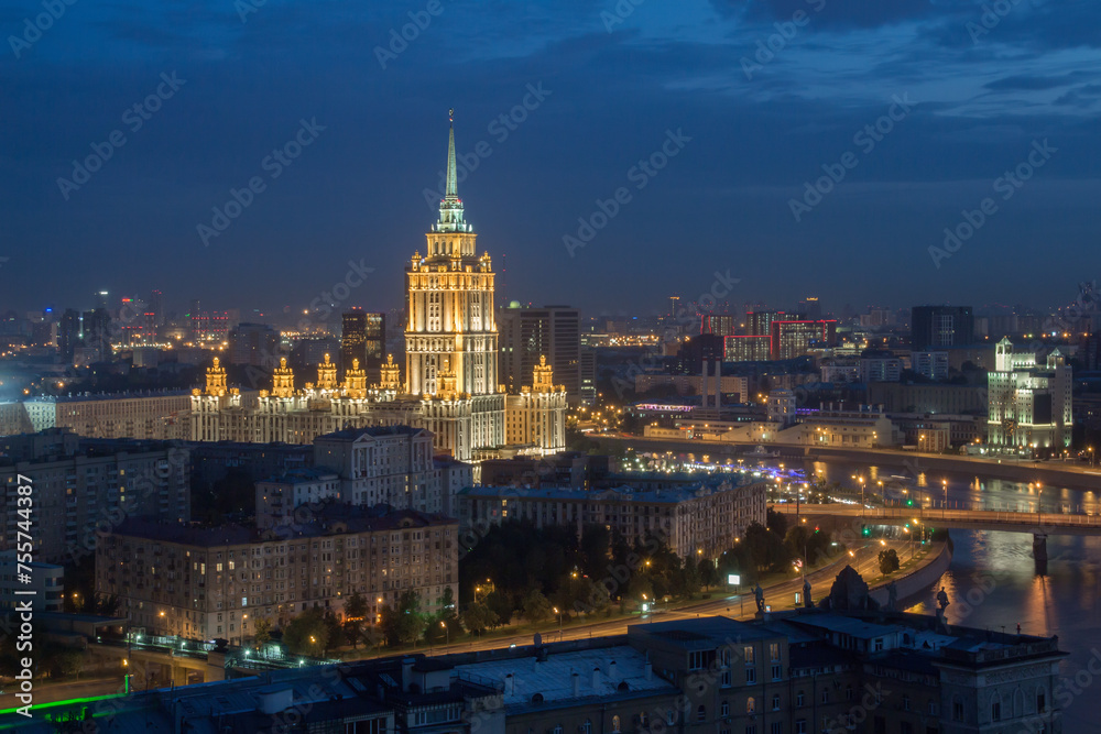 Ukraine hotel and Moscow river with bridge at night in Moscow, Russia