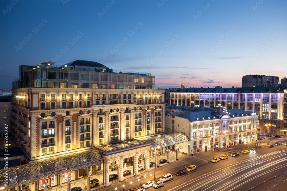 Fototapeta premium (long exposure) Tverskaya street (main street) of Moscow. Ritz-Carlton hotel at evening