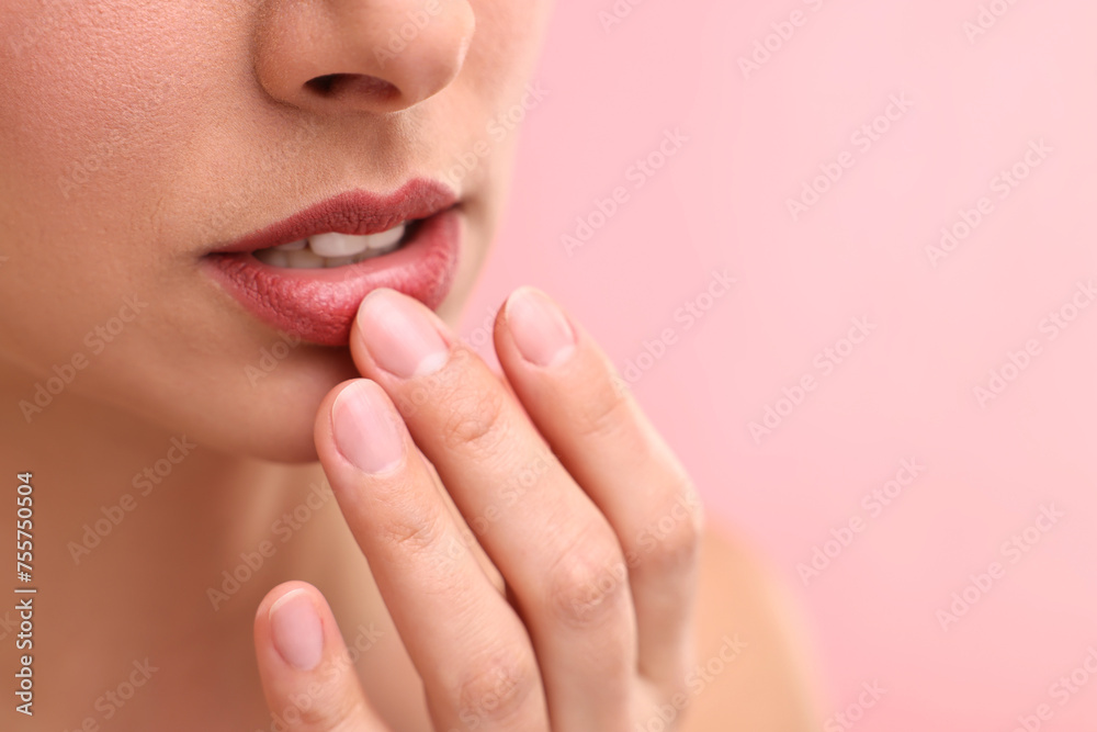 Woman with beautiful lips on pink background, closeup. Space for text