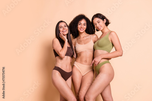 Studio no retouch photo of pretty delicate ladies dressed lingerie cuddling accepting imperfect skin empty space isolated pastel color background