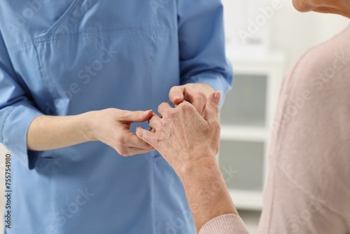 Arthritis symptoms. Doctor examining patient's hand in hospital, closeup photo