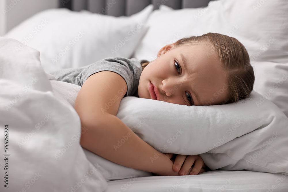 Little girl suffering from headache in bed Little girl suffering from headache in bed