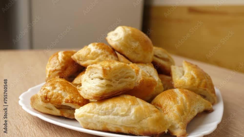 Freshly baked pies on a plate. Cooking pies.