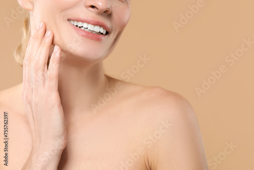 Woman with healthy skin on beige background  closeup. Space for text