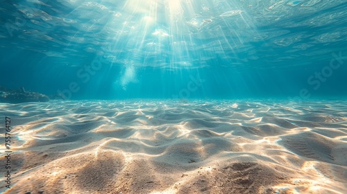 Seabed sand with blue tropical ocean above and sunny blue sky