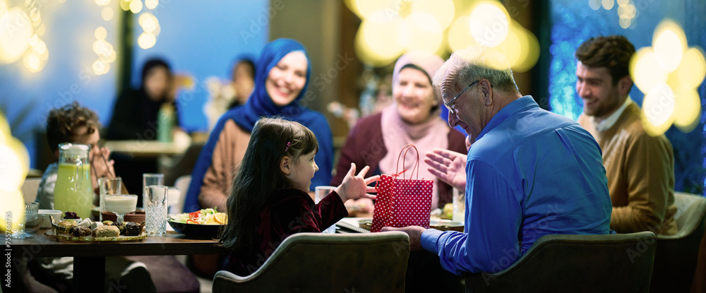 Grandparents arrive at their children's and grandchildren's gathering for iftar in a restaurant during the holy month of Ramadan, bearing gifts and sharing cherished moments of love, unity, and Grandparents arrive at their children's and grandchildren's gathering for iftar in a restaurant during the holy month of Ramadan, bearing gifts and sharing cherished moments of love, unity, and