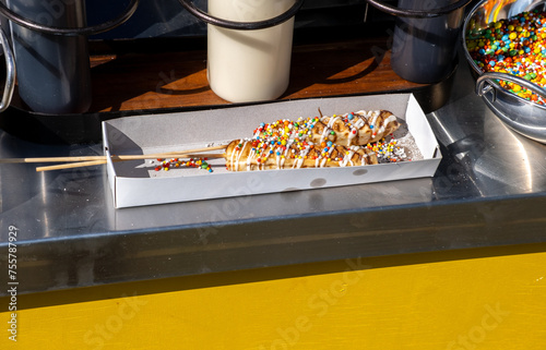 Sweet dough sticks sprinkled with colored sugar balls © vadiml