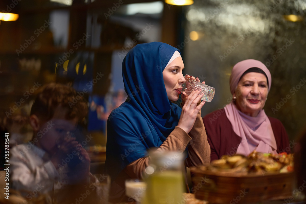 A modern and traditional European Islamic family comes together for iftar in a contemporary restaurant during the Ramadan fasting period, embodying cultural harmony and familial unity amidst a A modern and traditional European Islamic family comes together for iftar in a contemporary restaurant during the Ramadan fasting period, embodying cultural harmony and familial unity amidst a