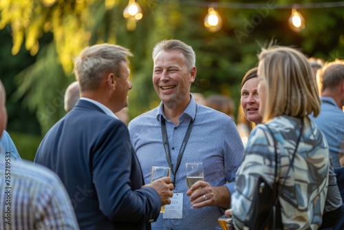 Group of business people at outdoor networking event. people with drinks in their hands talk to each other about business at a networking event