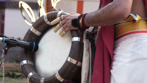 An artist playing Thavil, a South Indian percussion musical instrument photo