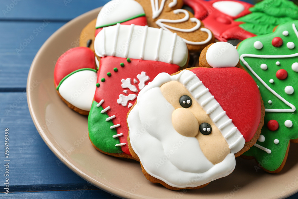Different tasty Christmas cookies on blue wooden table, closeup