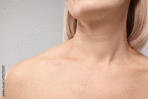 Woman with healthy skin on grey background, closeup