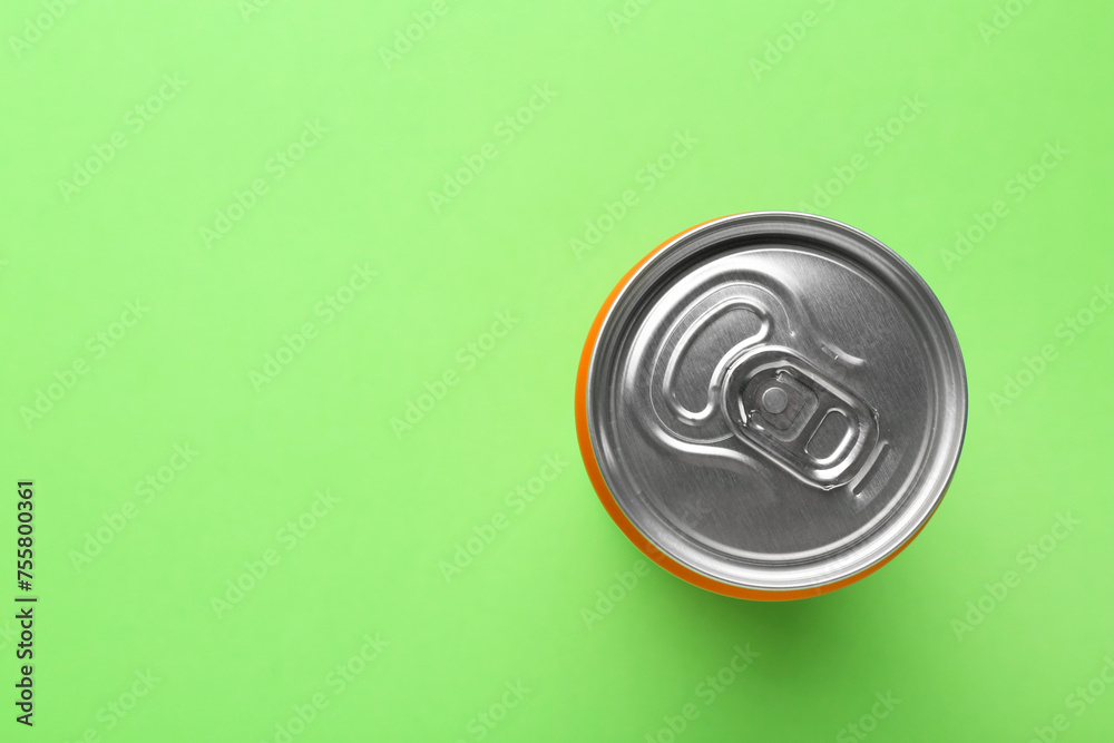 Energy drink in can on green background, top view. Space for text Energy drink in can on green background, top view. Space for text