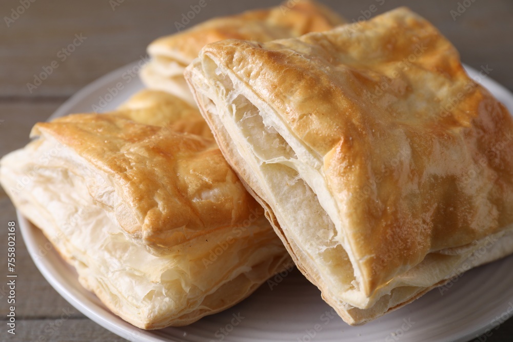 Delicious fresh puff pastries on table, closeup Delicious fresh puff pastries on table, closeup
