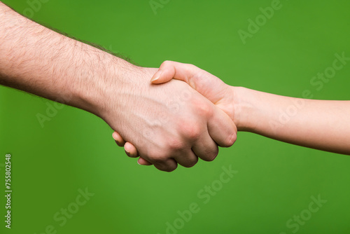Photo of two people arms palms hands shaking successfully contract signing isolated green color background