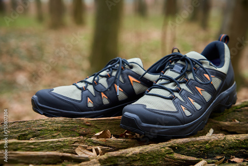 Hiking Boots in Nature. Sturdy trekking shoes against a backdrop of forest terrain. Concept of exploration and outdoor activities