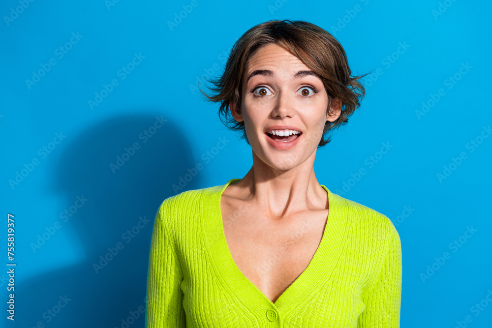 Photo of astonished pretty lady open mouth cant believe empty space isolated on blue color background - obrazy, fototapety, plakaty 