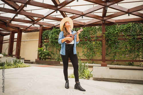 long shot of woman playing ukulele