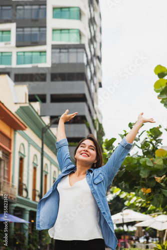 Vertical medium shot of woman raising arms