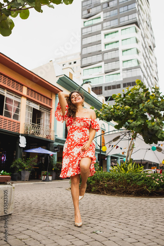 Wide shot of woman smiling in the city