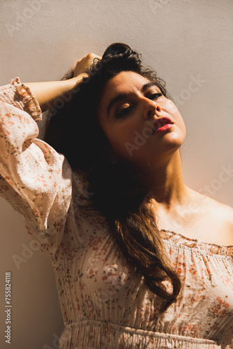 Woman touching her hair looking at camera