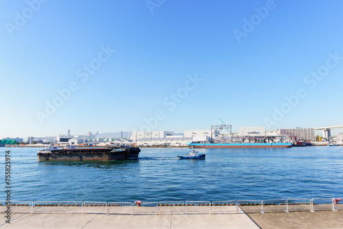 Fototapeta Naklejka Na Ścianę i Meble -  Sailing ships  through Osaka port , Marine cargo, large port city and commercial center on the Japanese island of Honshu, Osaka, Japan.