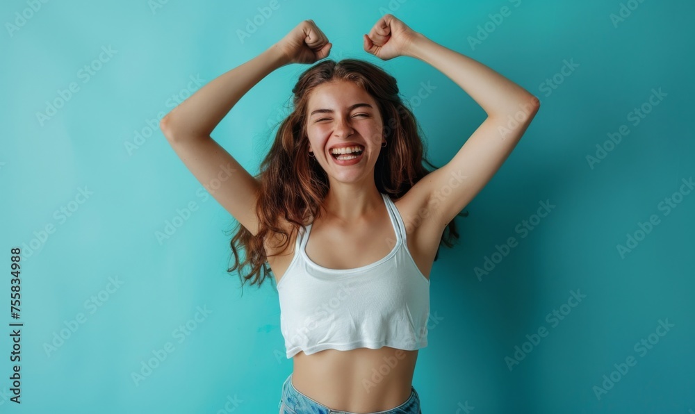 Fototapeta premium Smiling woman standing confidently showing off her toned and beautiful body after achieving her diet goals