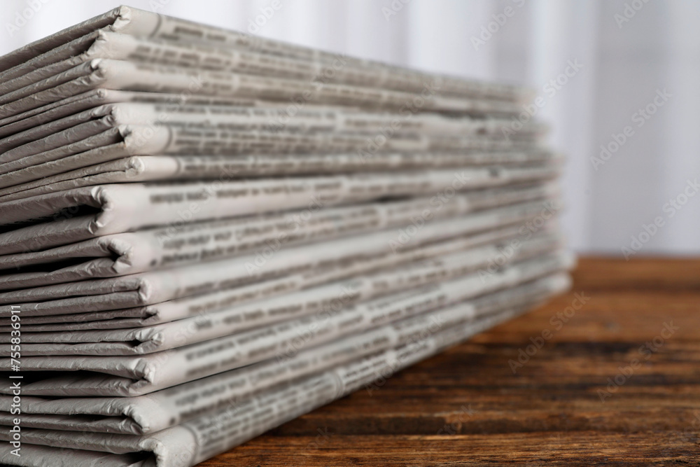 Stack of newspapers on wooden table, closeup. Journalist's work Stack of newspapers on wooden table, closeup. Journalist's work