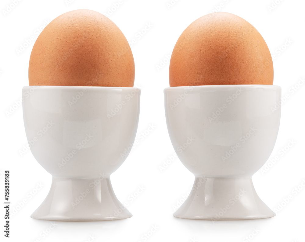 Brown chicken eggs in the egg cups isolated on white background. File contains clipping paths. Brown chicken eggs in the egg cups isolated on white background. File contains clipping paths.
