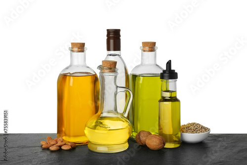 Vegetable fats. Different cooking oils and ingredients on wooden table against white background