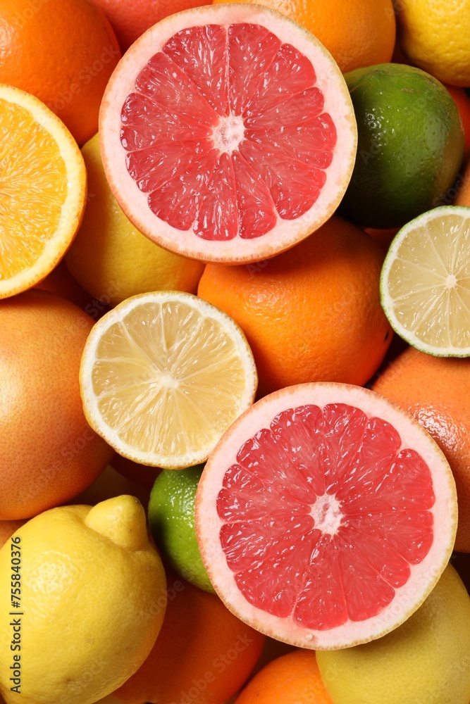 Fototapeta premium Different fresh citrus fruits as background, top view