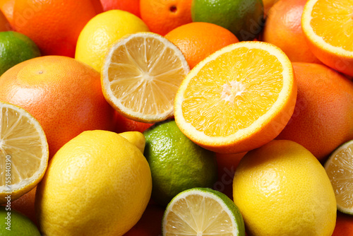 Different fresh citrus fruits as background  closeup
