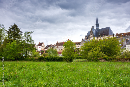 Picturesque view of Montresor village with  church of Saint John the Baptist through the nature environment. Indre-et-Loire, France. Montresor is listed as one of most beautiful villages in France.  photo