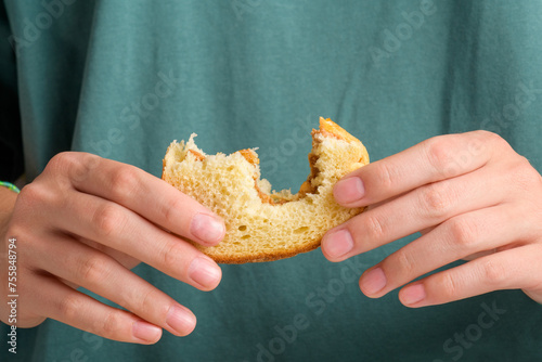 Female hands holding a bitten peanut butter sandwich with honey of wheat bread, have a breakfast. Typical snack food, food lifestyle, domestic life, american breakfast