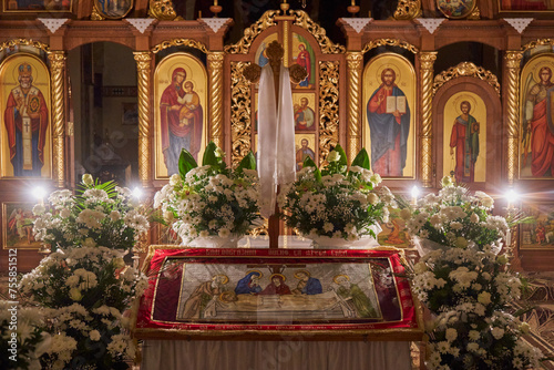 shroud in the church, the interior of the church at night with the shroud decorated with flowers, Easter Friday photo
