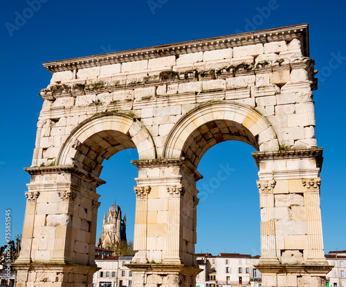 Ancient Roman arch (Arch of Germanicus) and cathedral Saint-Pierre seen at background. Saintes, Charente-Maritime, France. Travel in South West France. In Roman times, Saintes was known as Mediolanum. © Elena Dijour