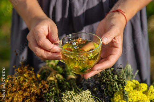 A woman brews herbal tea. Selective focus. © yanadjan