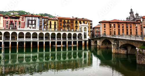 Tolosa town. Colorful buildings, market and bridge, reflection in river. Basque Country, Spain photo